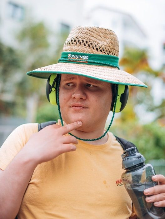 Guy Wearing Large Straw Hat — NDIS Provider on the Sunshine Coast, QLD